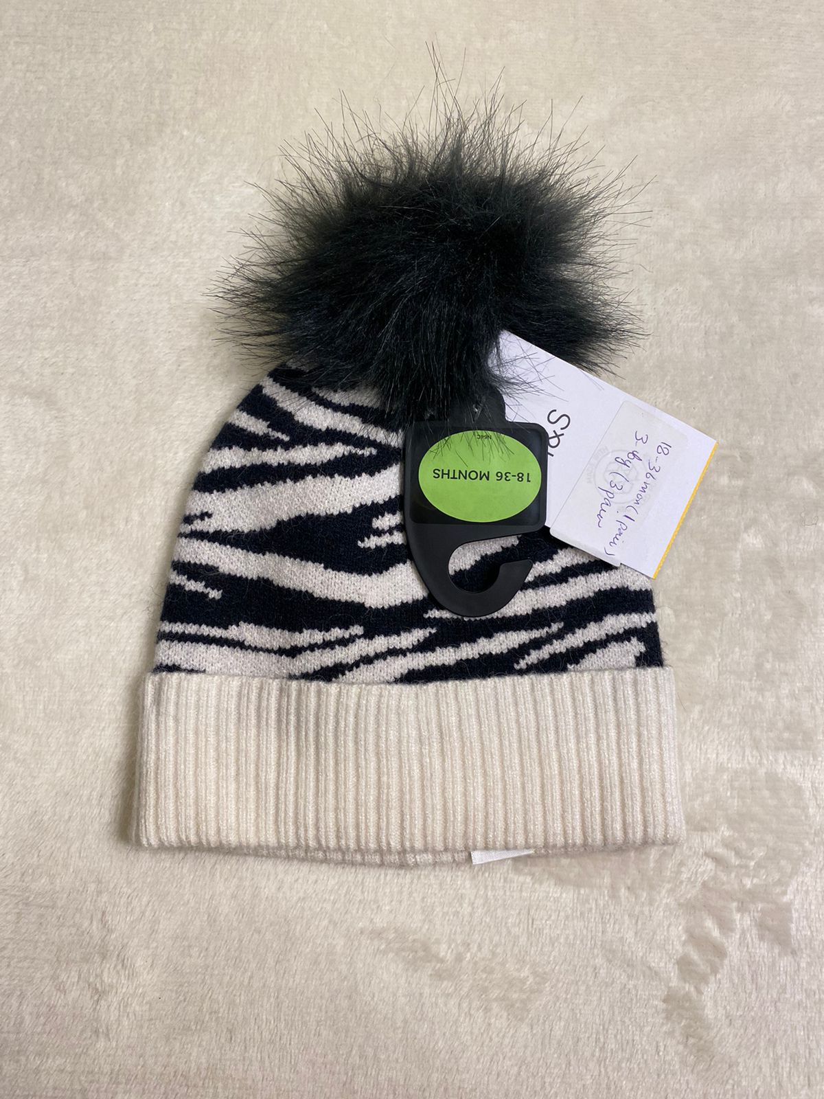 M&S zebra pom pom cap